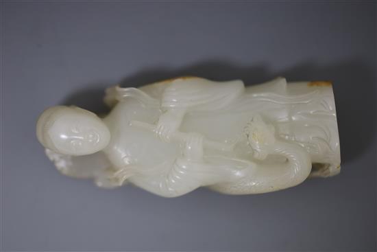 A fine Chinese white and russet jade group of Xi Wangmu and a phoenix, 19th/20th century, 9.5cm high, wood stand